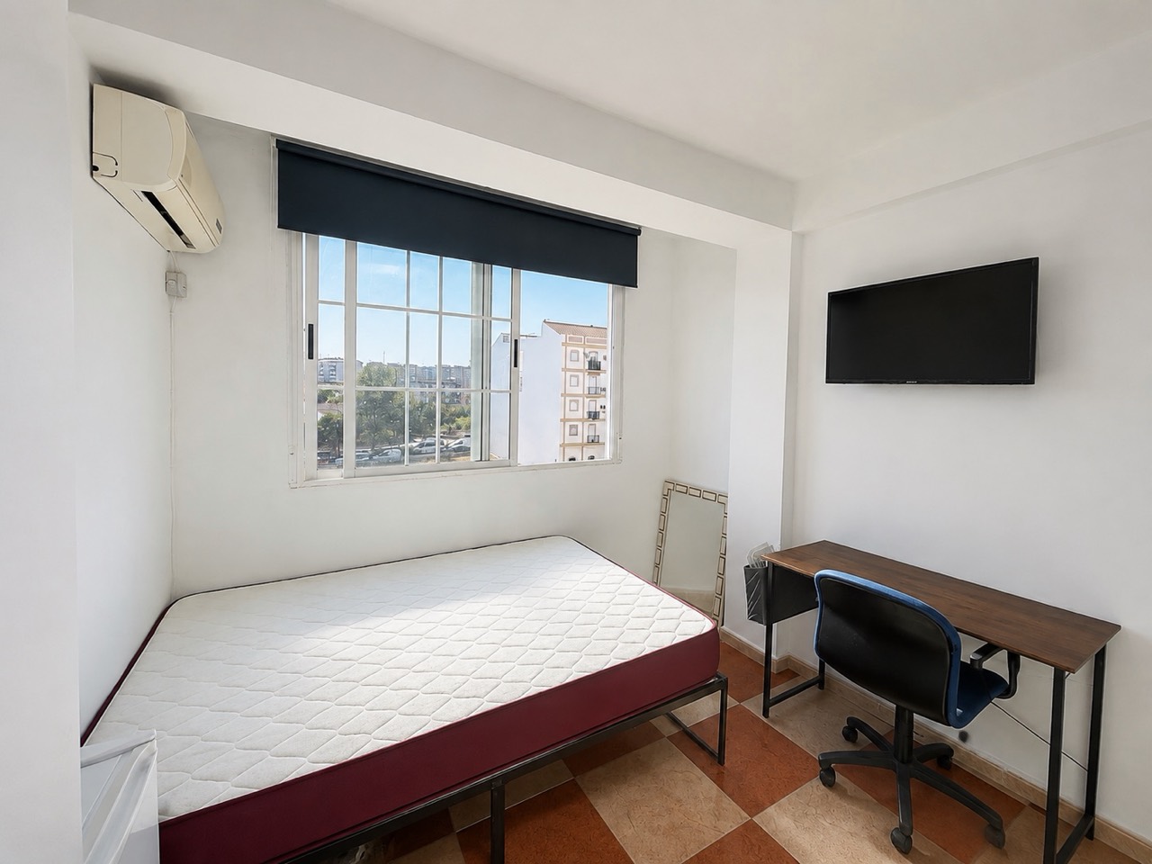 Room H61 · main view with bed, air conditioning, TV and desk