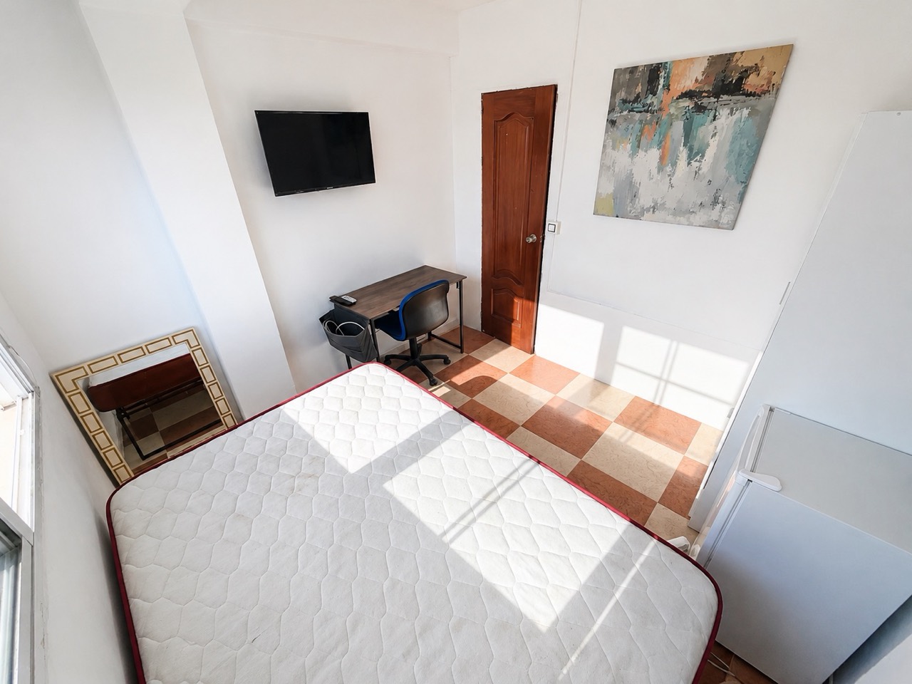 Room H61 · reverse view with desk, TV, mirror and door